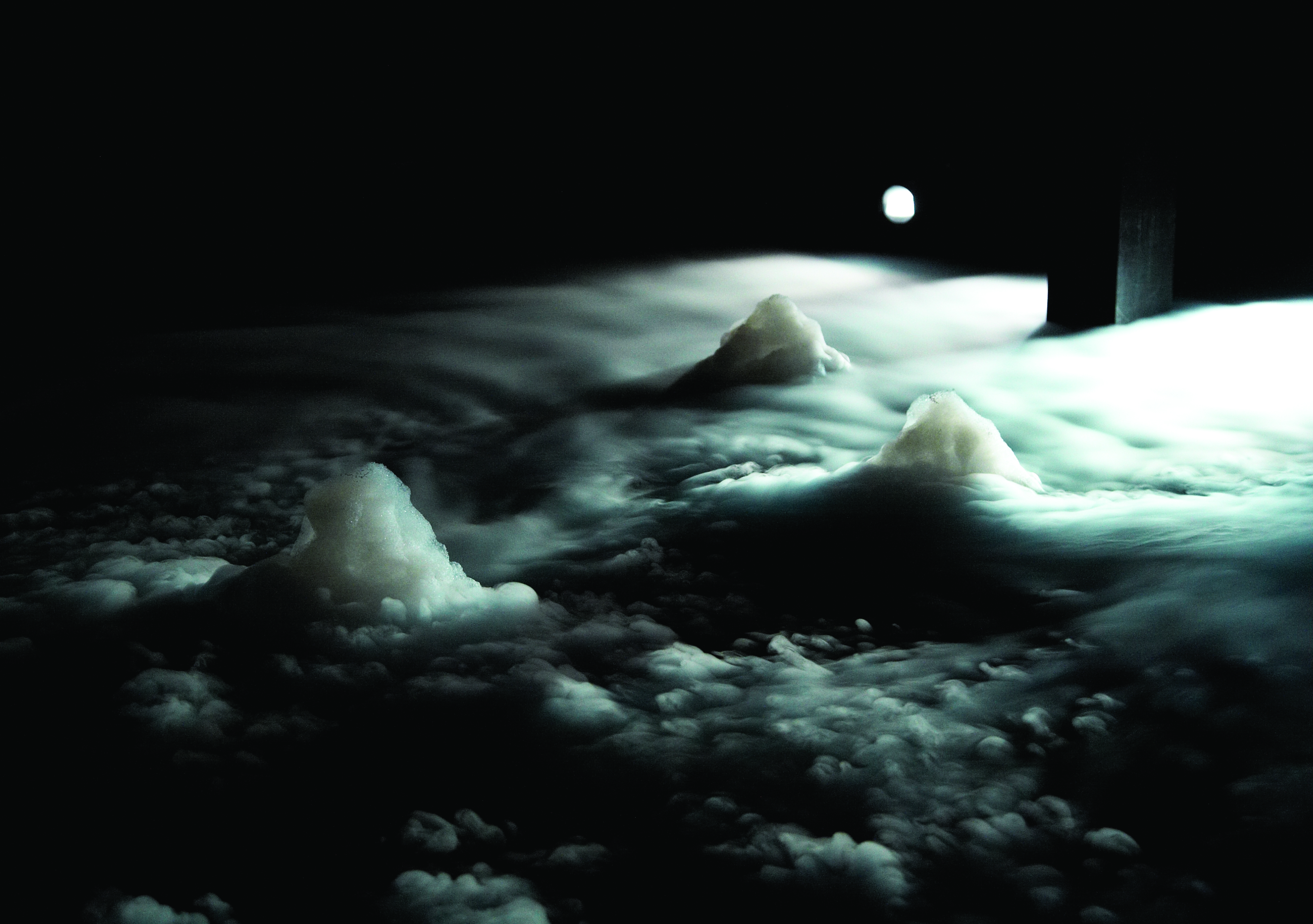 image of cloudy backlit landscape at night, from Mette ingvartsen's Evaporated Landscapes project.