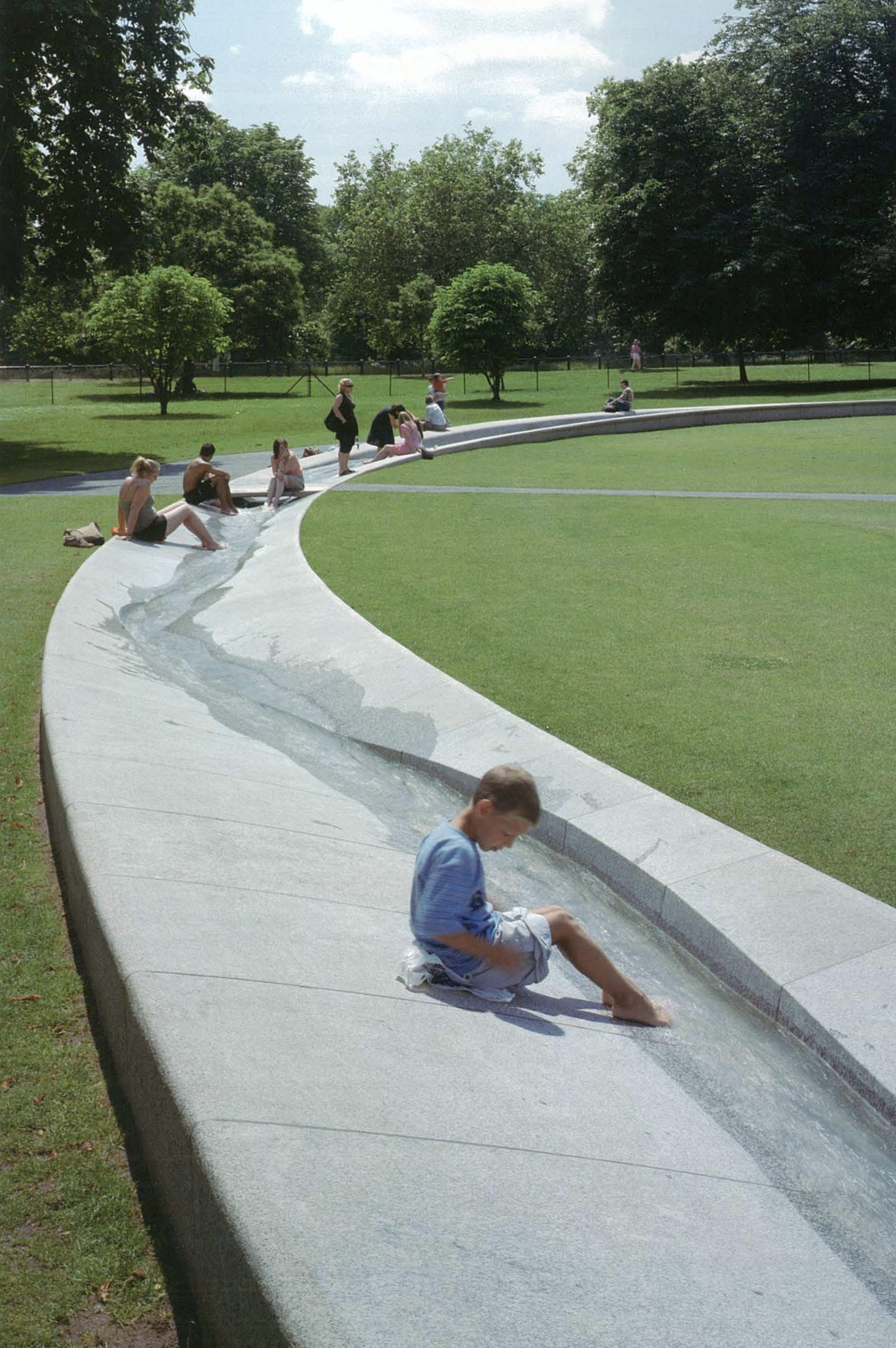 People playing in the Princess of Wales Memorial Fountain